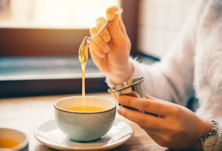 Image of an office worker adding honey to a cup of tea
