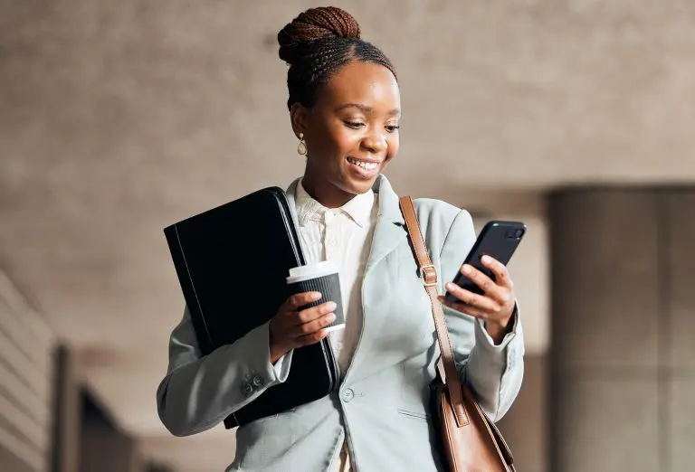Image of an office worker with a coffee and a phone