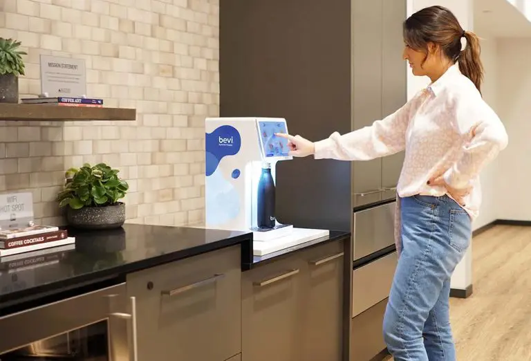 Image of an office worker operating a water dispenser